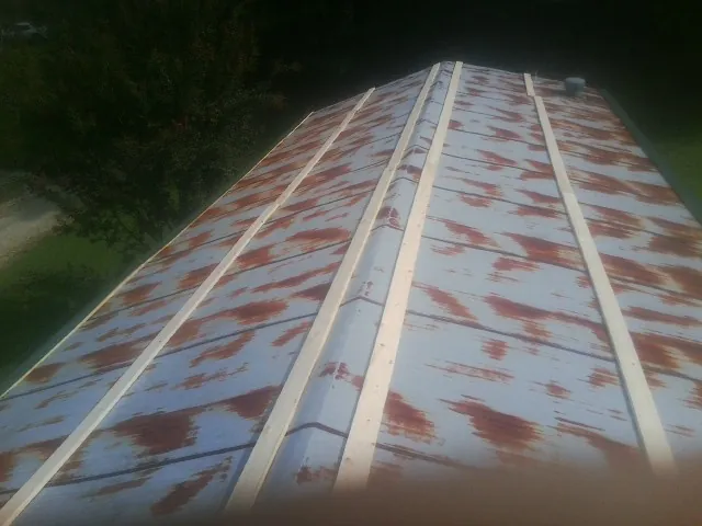 Rusted metal roof panels with new wood purlins before replacement — Storm Damage Roof Repair in Branchport by Roofing Brothers
