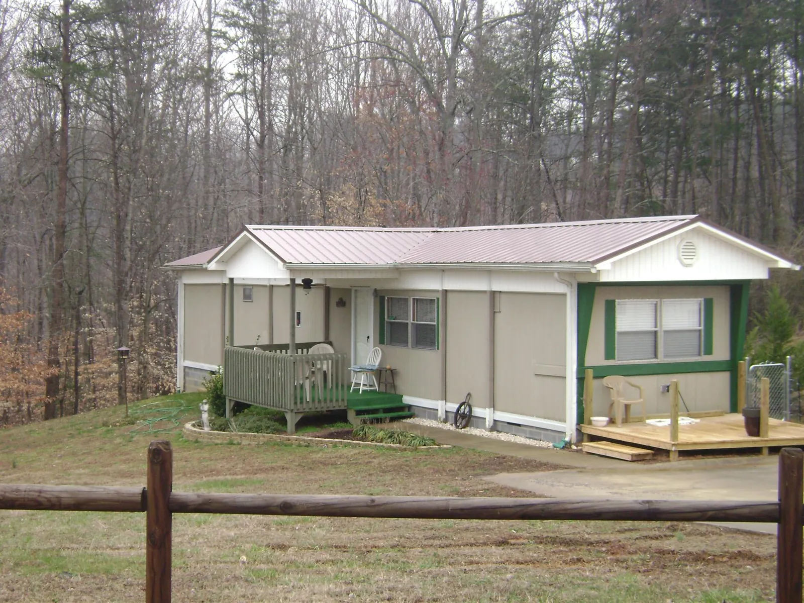 Mauve metal roof on a manufactured home with a new front deck in Branchport